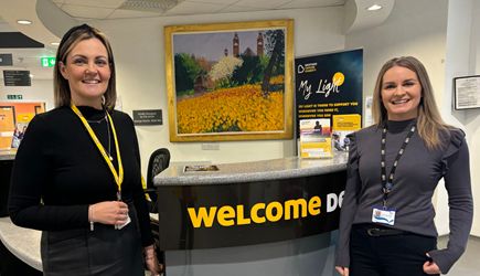 Donna Caldwell and Chloe Wilkinson stadning at the welcome desk
