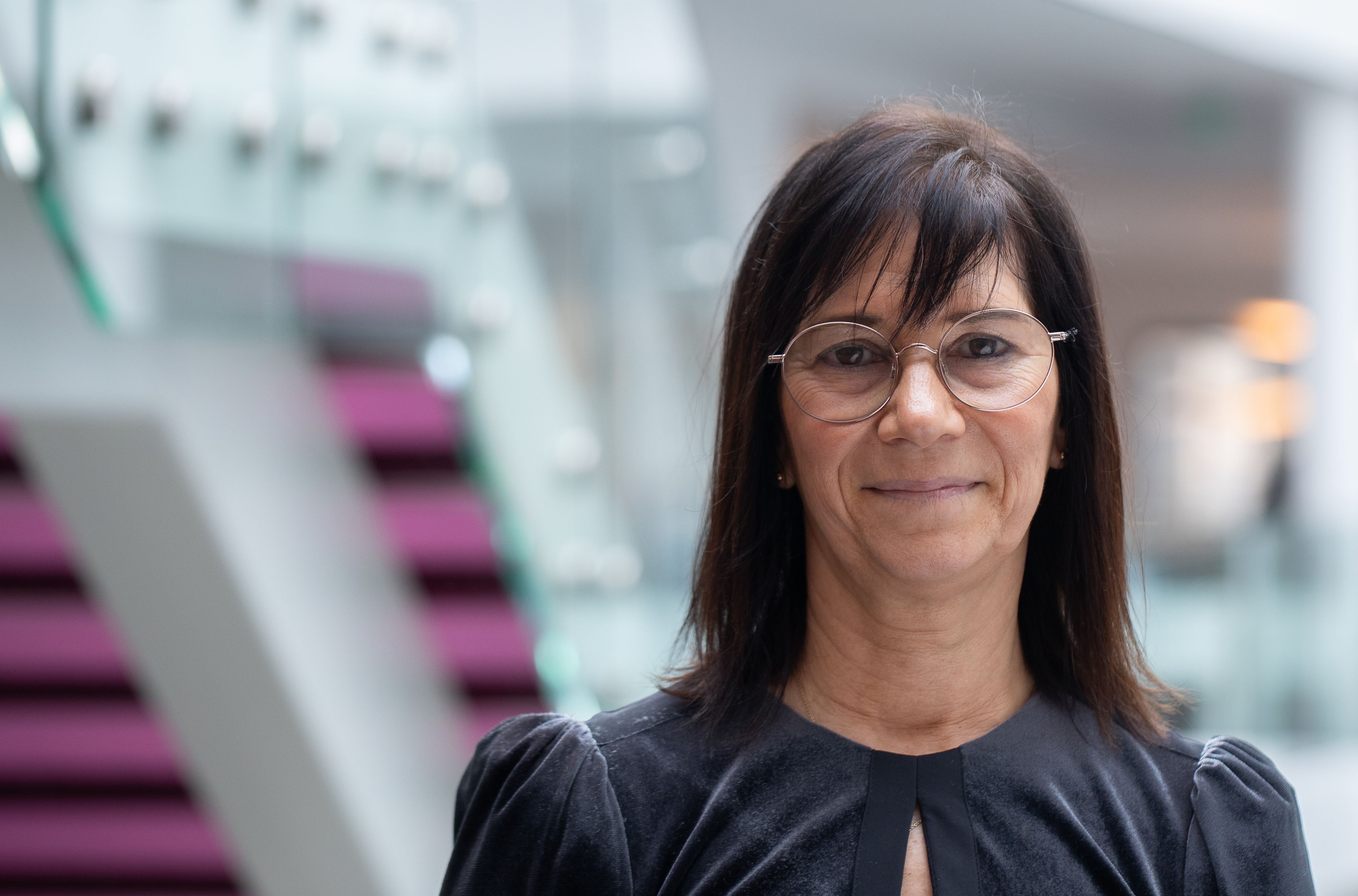 Heidi Probst wearing claear glasses and grey sleeved dress